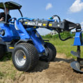 auger attachment for mini loader in action